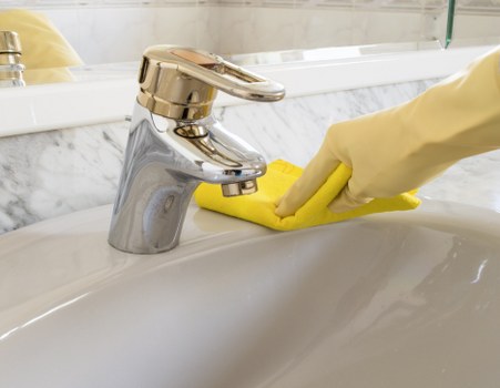 Cleaner wearing PPE while working on a carpeted floor